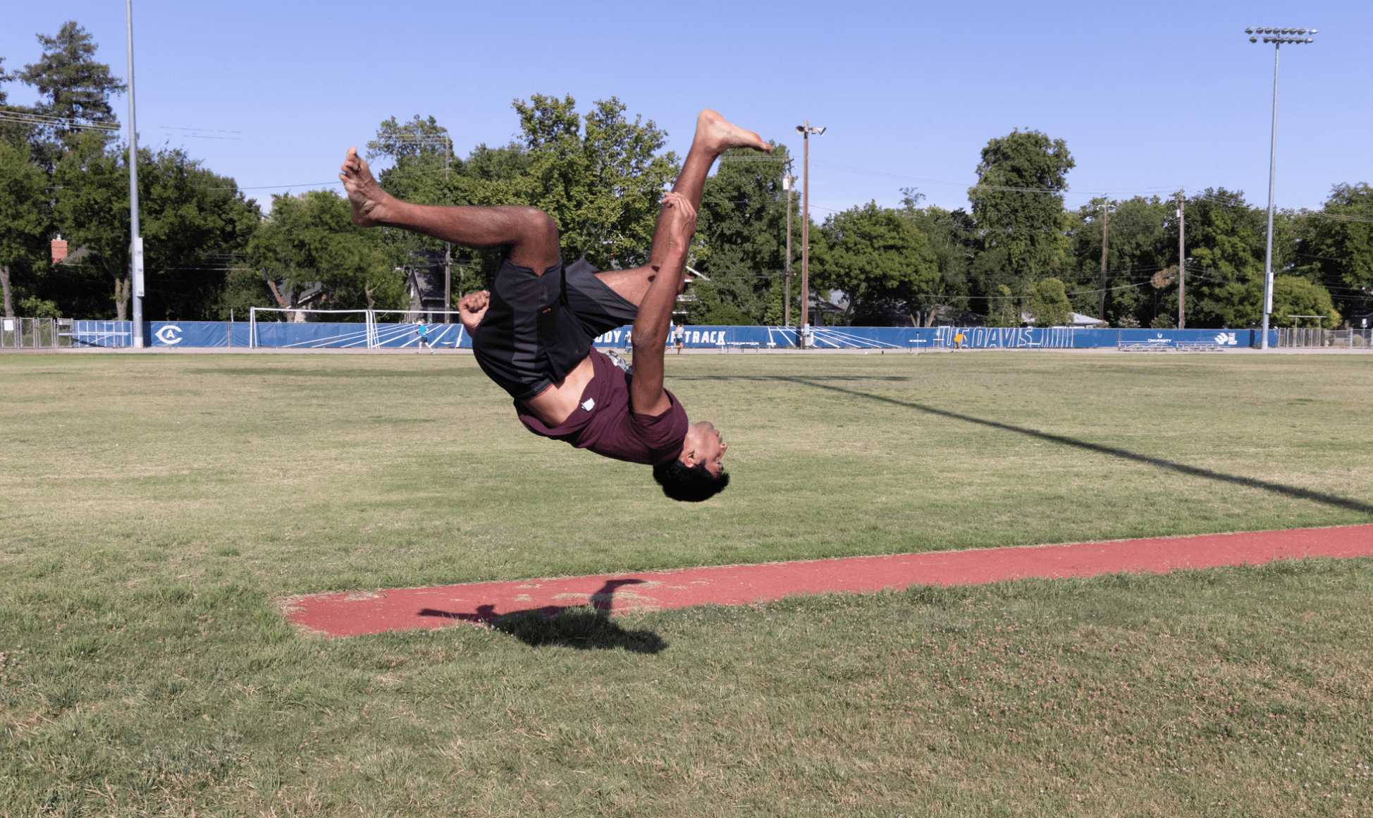Saha doing a flip on a track field