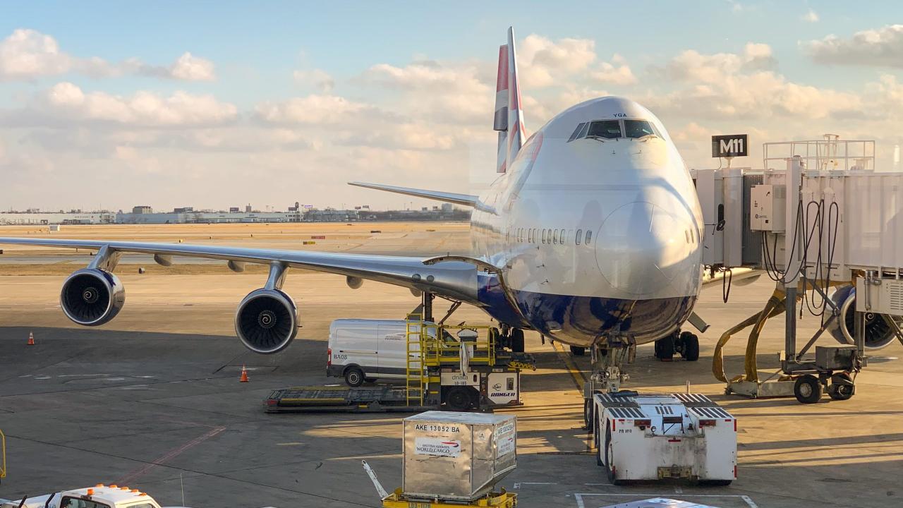 A jet plane parked at an airbridge. 