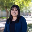 A portrait of Mariela Ramirez with trees in the background