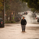 person standing in flooded road