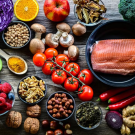 A table with fresh fruits and vegetables and meats